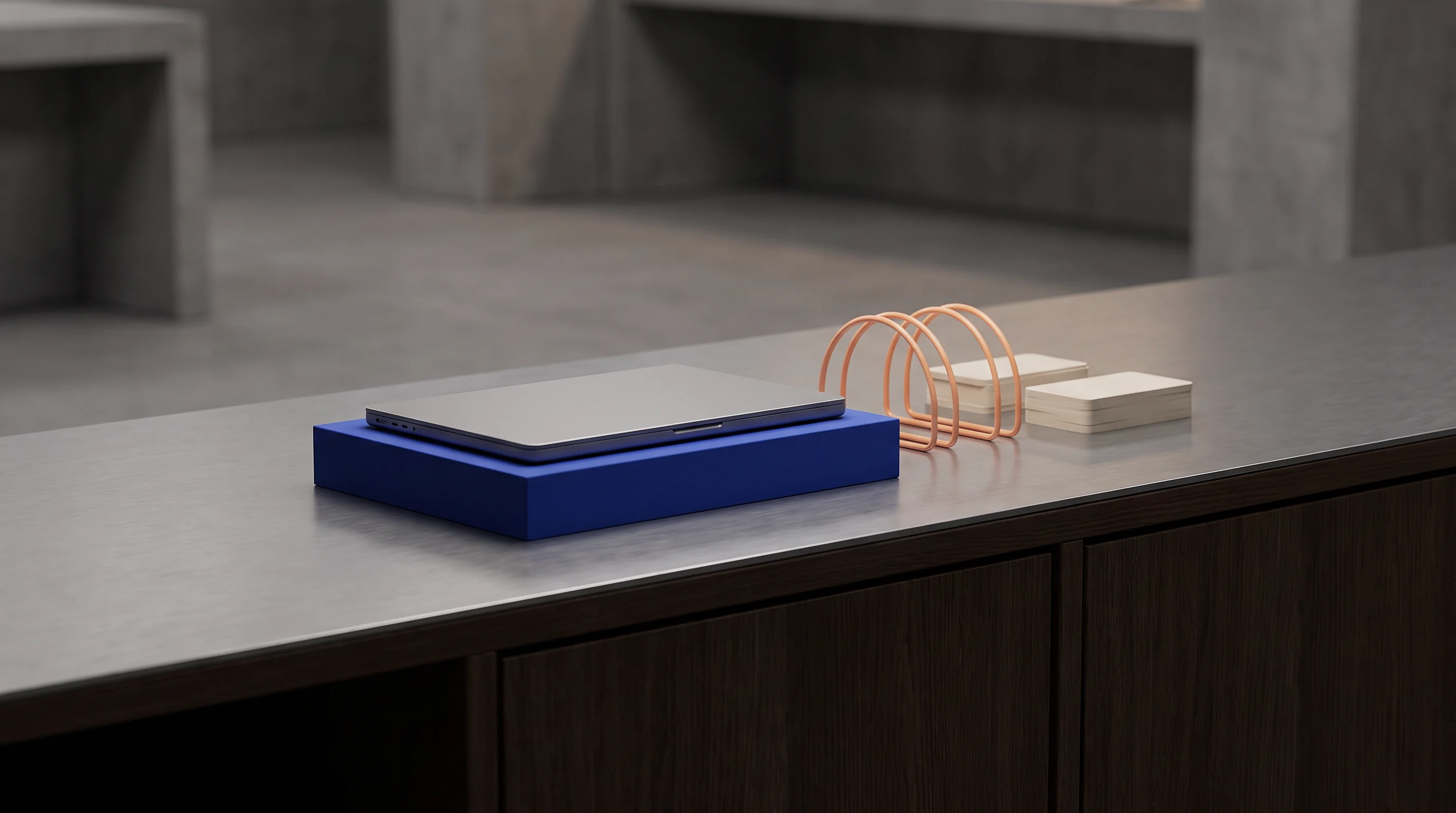 A blue tray with cable rests on a black metal work counter