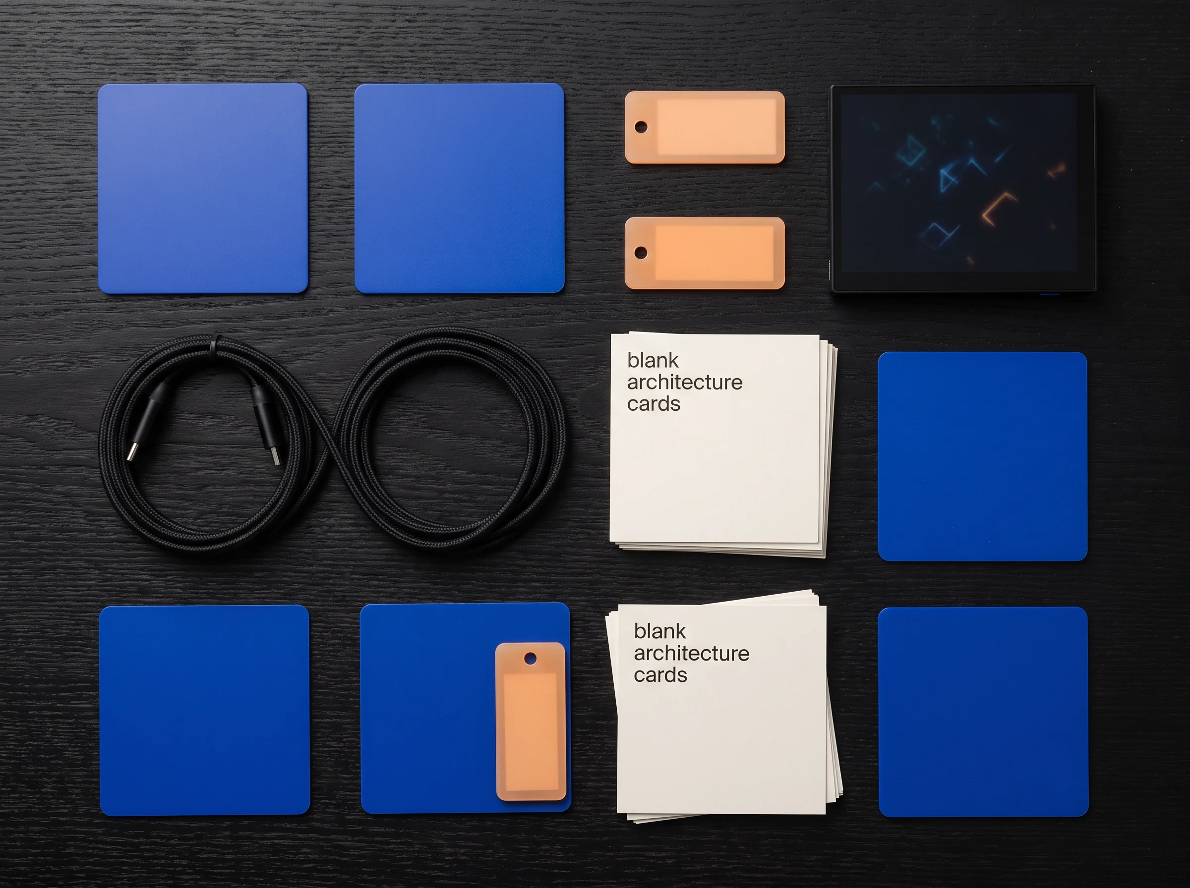 Cables, cards and blue materials laid out in a flat work arrangement